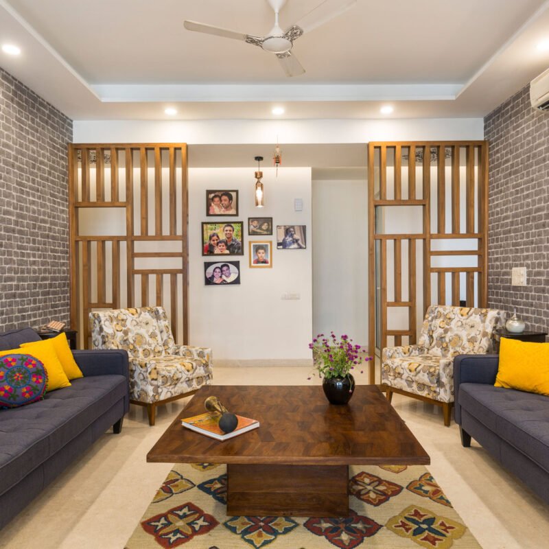 2 BHK Contemporary Flat Design with Earthy Toned Furniture and Dark Wood Flooring
