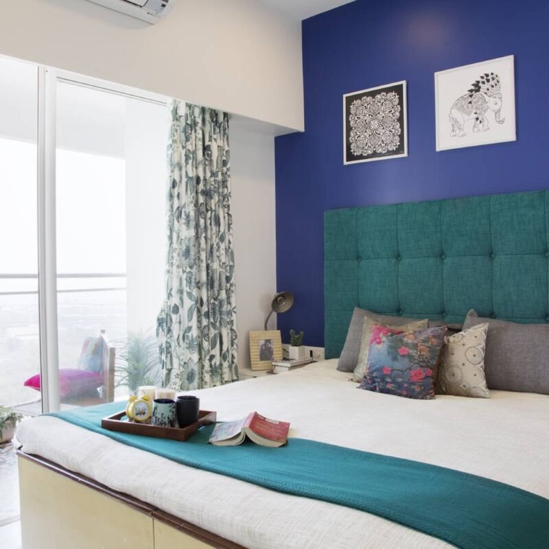 Contemporary 2BHK Flat Design with Blue Accents and Parallel Kitchen