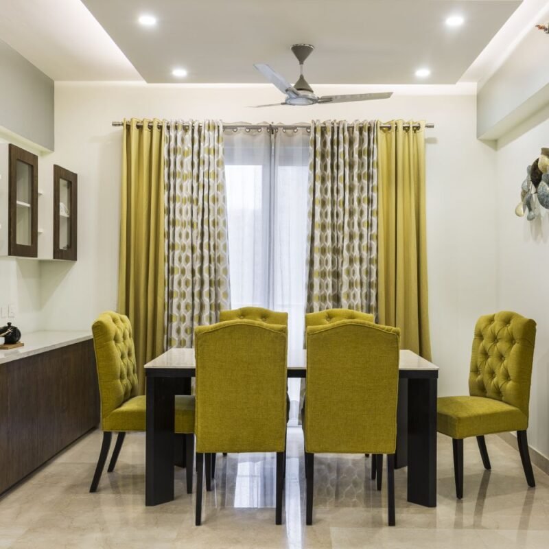 Contemporary 1BHK Flat Design with Parallel Kitchen and Yellow Highlights
