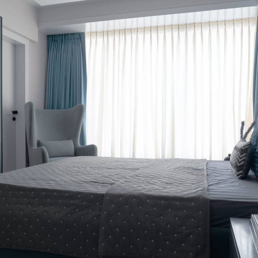 Modern Guest Bedroom Design with Accent Chair and Stone Accent Wall