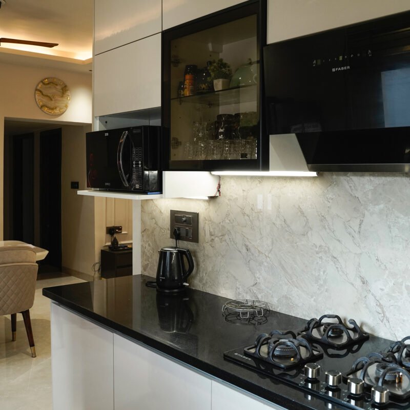 Modern L-Shaped Kitchen Design with Marble Backsplash and Glass Cabinets