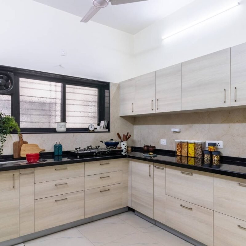 Contemporary 1BHK Flat Design with L-Shaped Kitchen and Swing Wardrobe