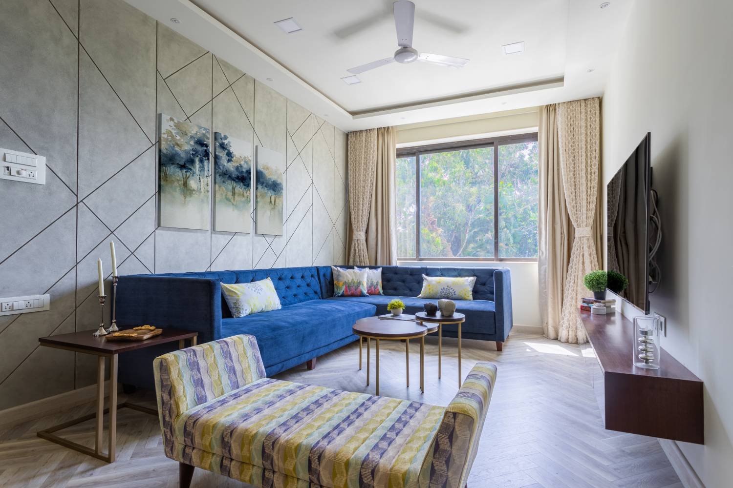 Modern 1BHK Flat Design with L-Shaped Blue Sofa and Wall Paneling