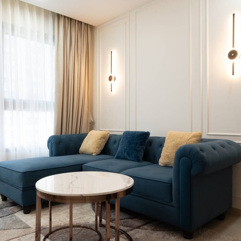 Modern Living Room Design with Dark Blue L-Shaped Sofa and Marble Table