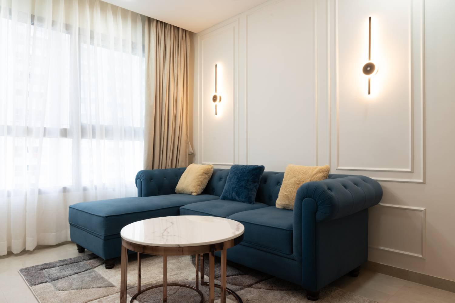 Modern Living Room Design with Dark Blue L-Shaped Sofa and Marble Table