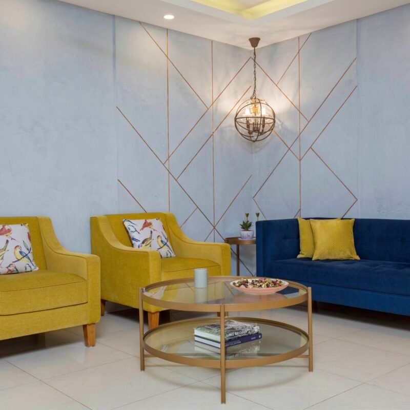 Contemporary Living Room Design With Mustard Chairs and Navy Blue Sofa
