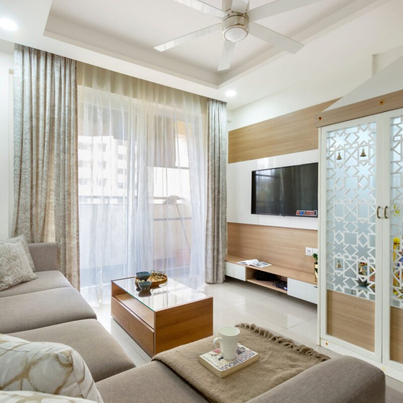 Modern Living Room Design With Sectional Sofa and Pooja Cabinet