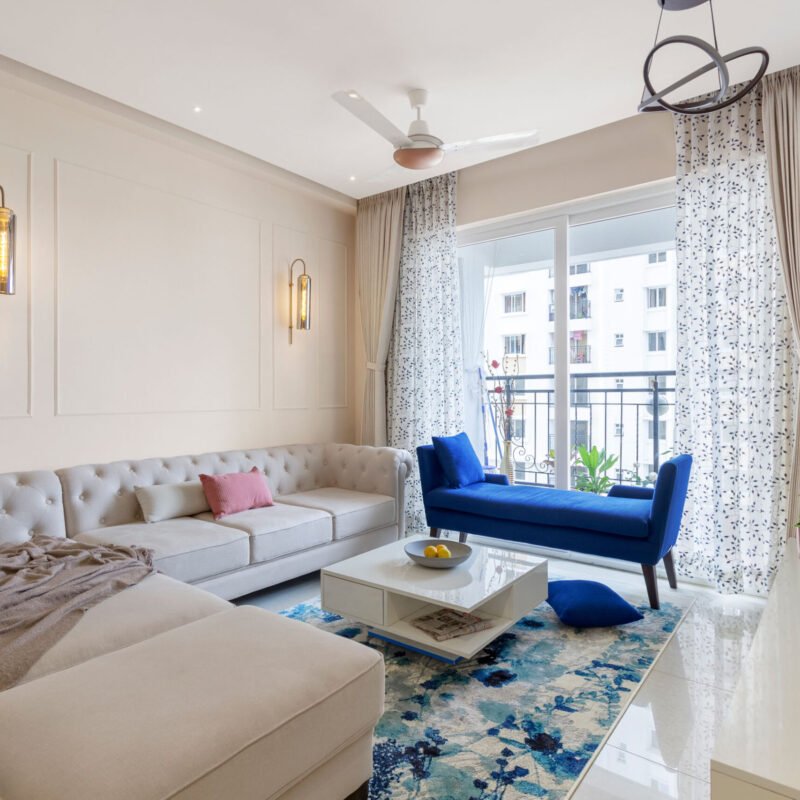 Contemporary Living Room Design With Beige Sectional and Blue Accent Bench