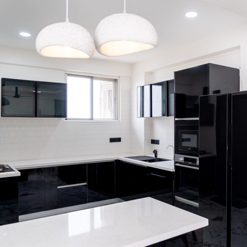 Modern Black Island Kitchen Design With Glossy Cabinets and Quartz Top